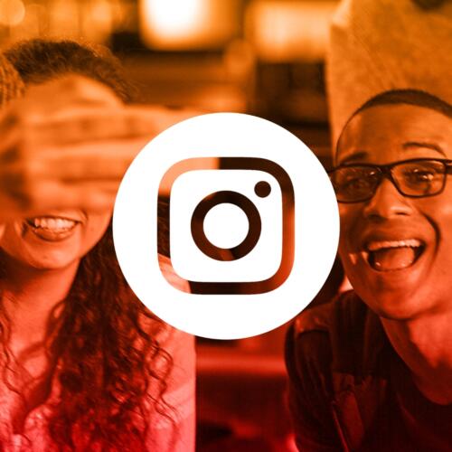 Instagram logo over younger male and female taking a selfie